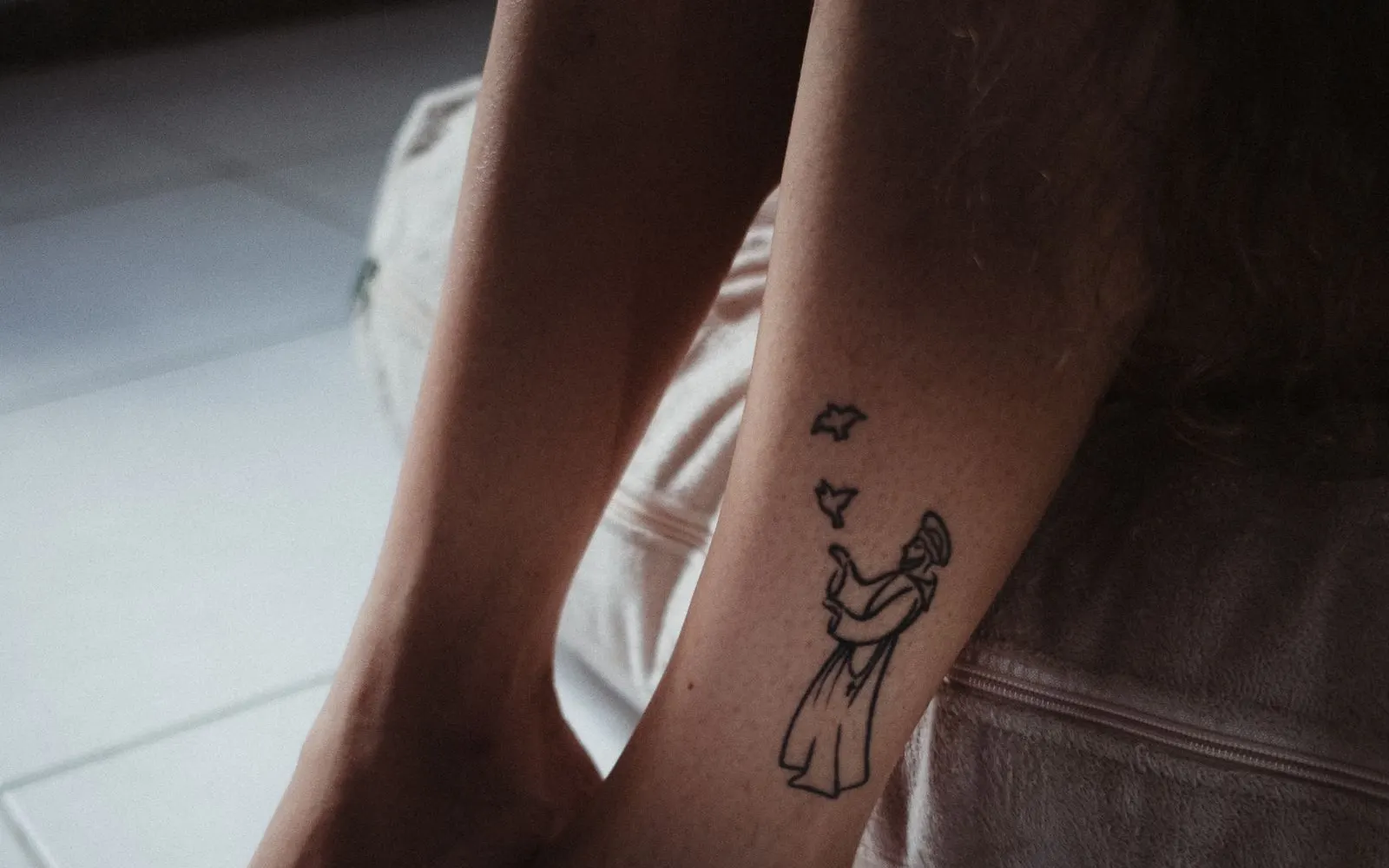 A small tattoo on the side of a foot, one of the slower areas to fade