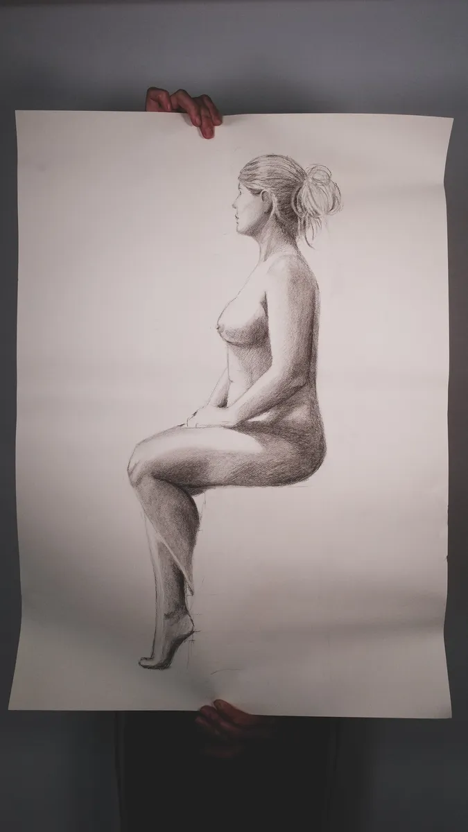 Figure drawing of a seated nude in profile, held up by Britt Beale