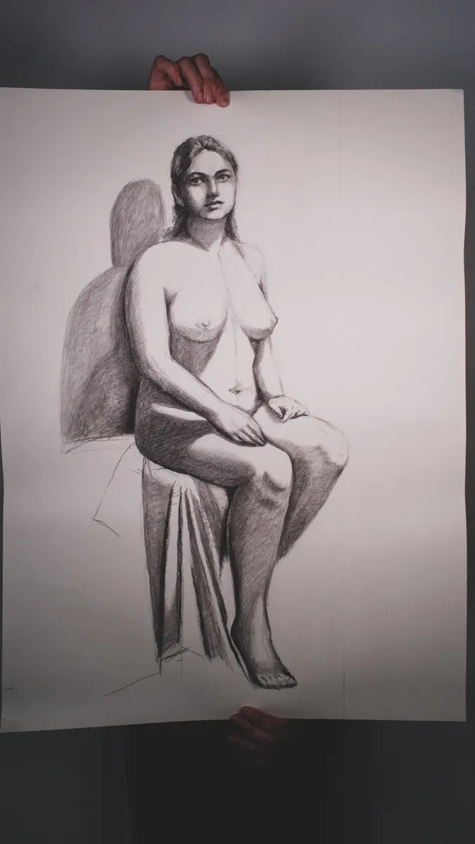 Figure drawing of a seated nude, held up by Britt Beale